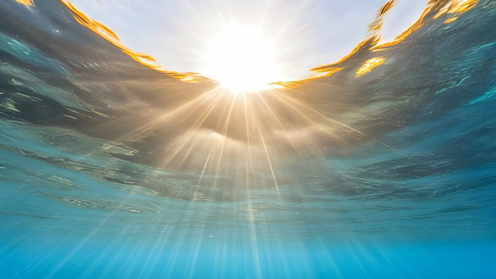 Sunlight breaking through the rippling surface of the sea, seen from underwater, a view inside the Ocean Abyss 360° world