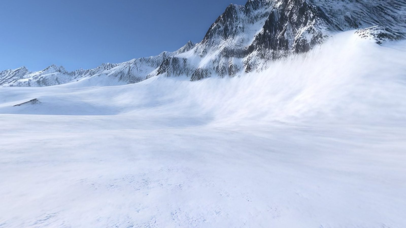 A snowfield sweeping up to rocky, snow-capped peaks under a blue sky, a view inside the Frozen Glacier 360° world